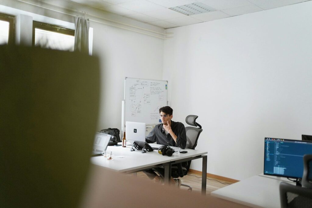 Man sitting at a desk in a bright, open office