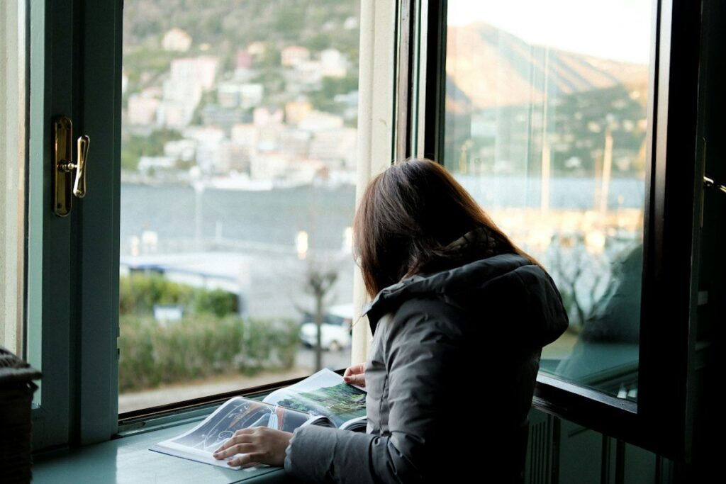 Trader reading a printed rulebook at a desk to understand what a trading plan should include