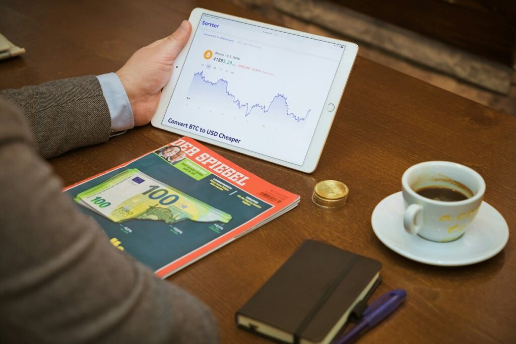 Trader checking market prices on a tablet before deciding whether to trade the session