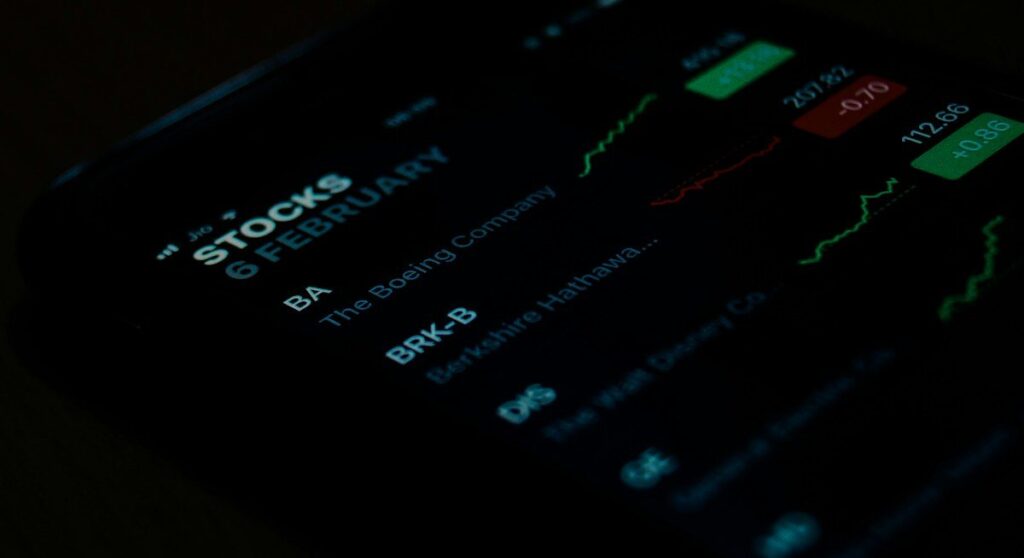 Phone showing a list of share prices and a chart