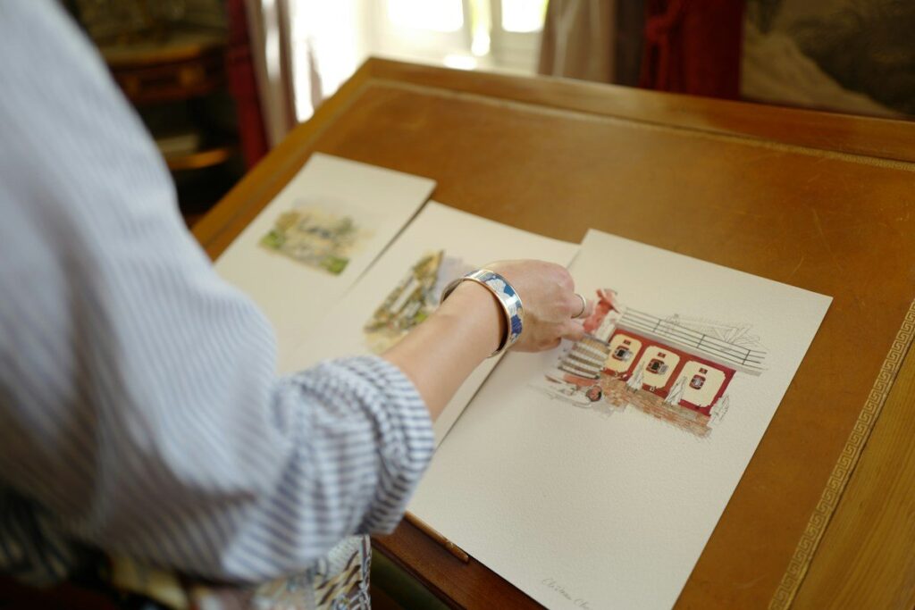 Person sorting printed sheets on a desk to review progress while learning to trade