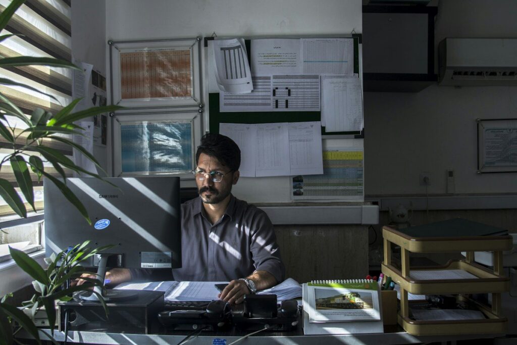 Man working at a desk with printed papers in an office