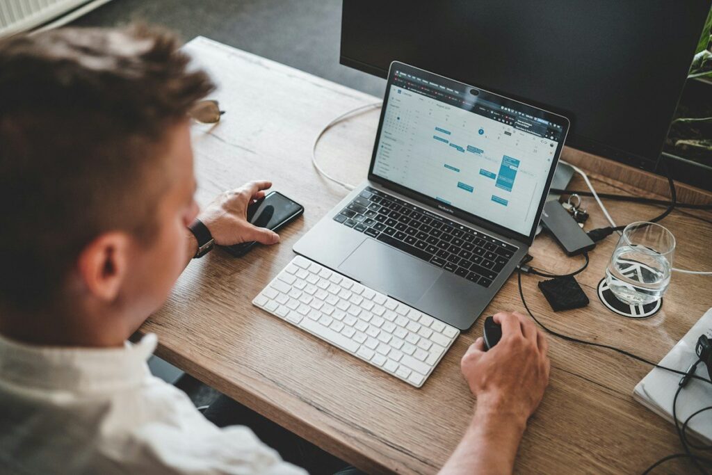 Trader reviewing notes on a laptop while checking whether a range breakout is the start of a new trend