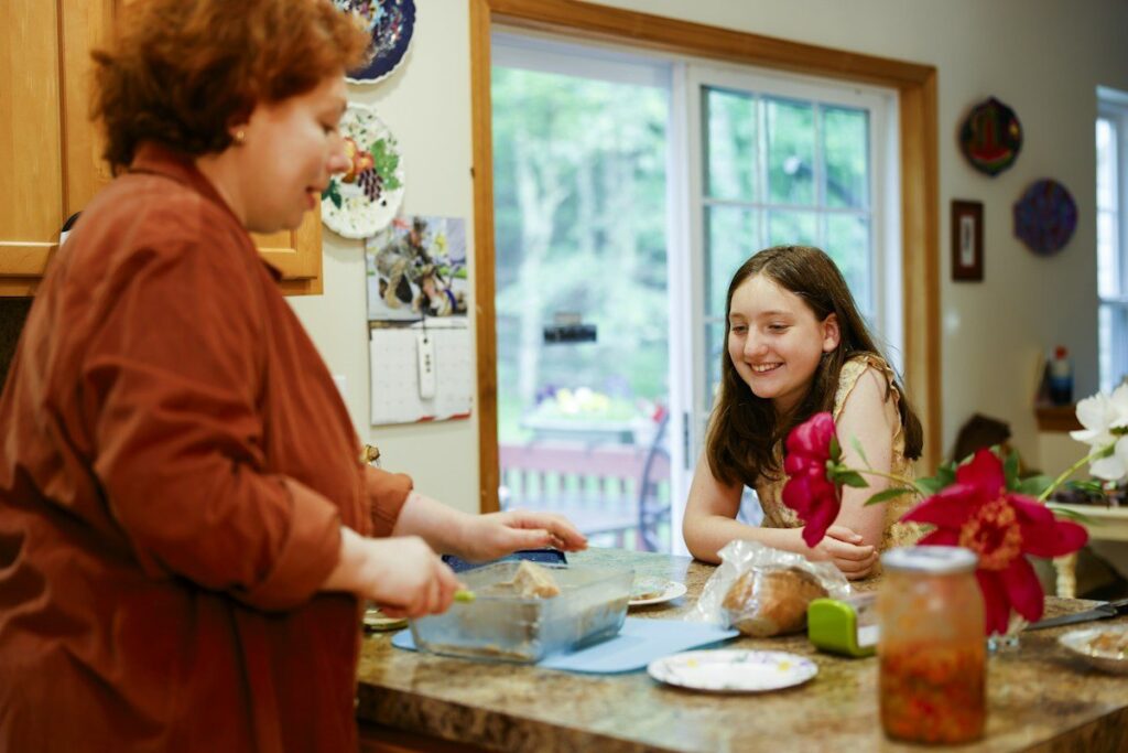 Two people talking at a kitchen counter, checking a trendline trade plan together