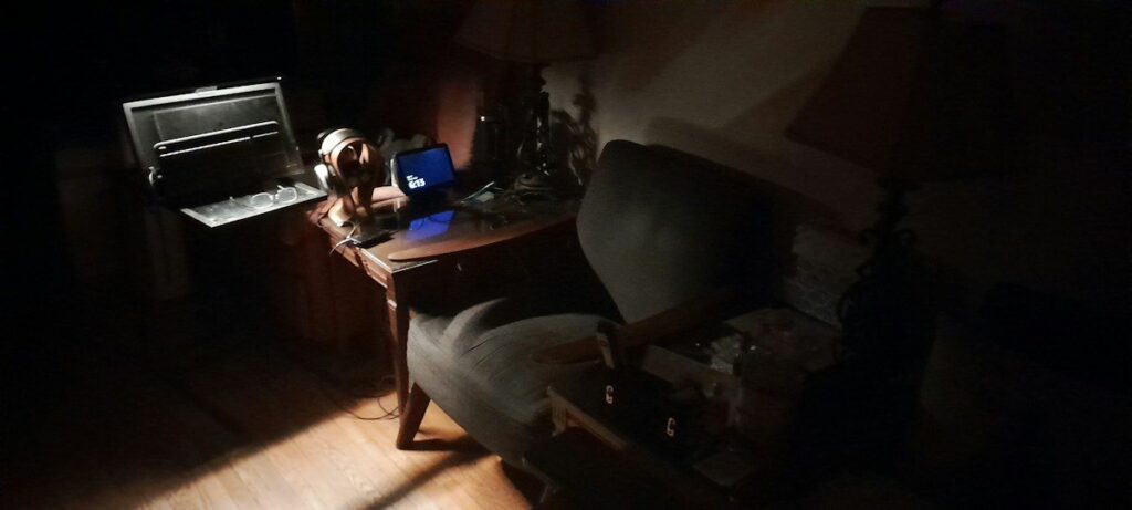 Laptop glowing in a dark room as a fast move runs, the moment FOMO in trading takes hold