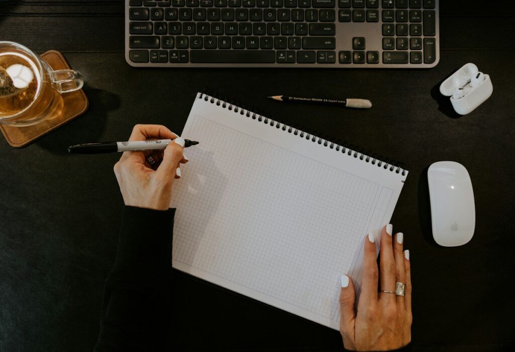Trader writing a numbered list of risk rules in a notebook as the base of a risk model