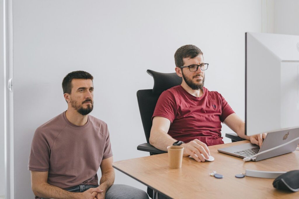 Two men looking at a monitor in an office