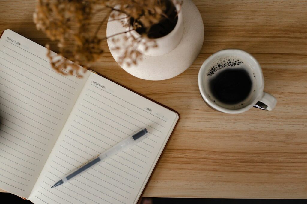 Open diary with handwritten notes, a trading journal where revenge trades are tagged and reviewed