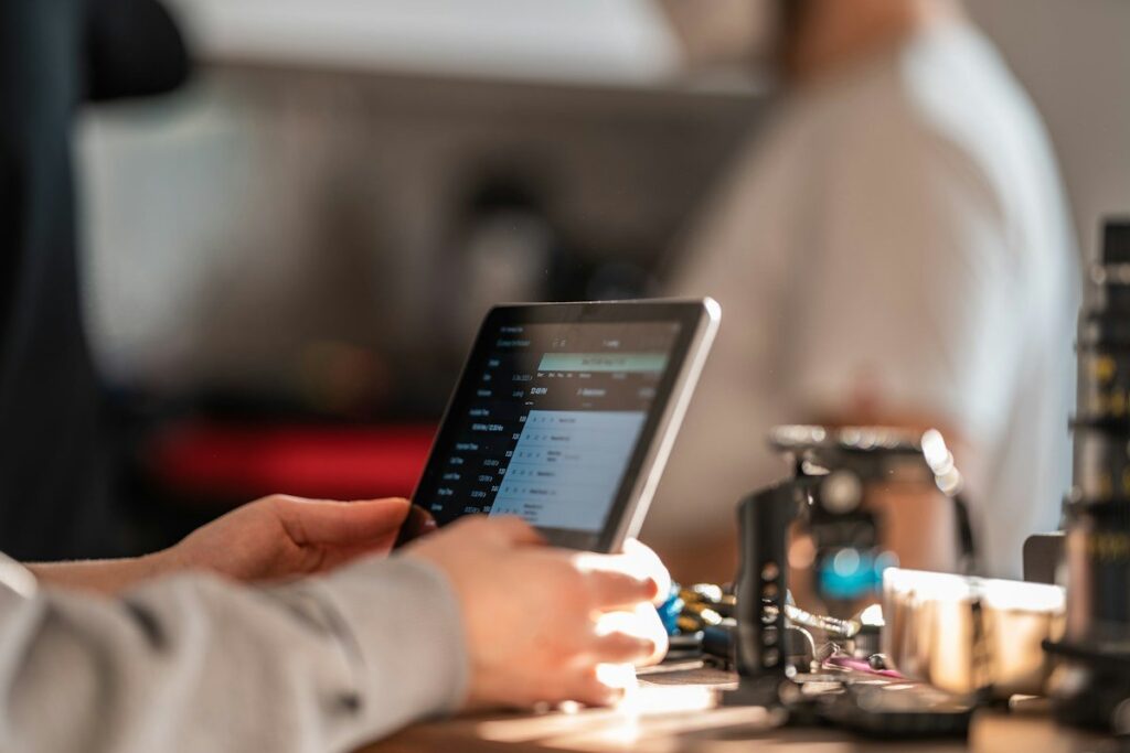 Hand placing an order on a tablet trading app, setting the entry and stop for a hypothetical order block trade