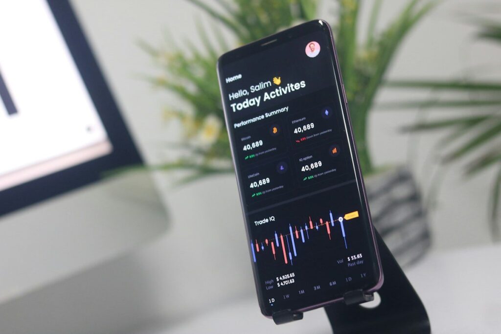 Phone on a stand showing an app with a small chart