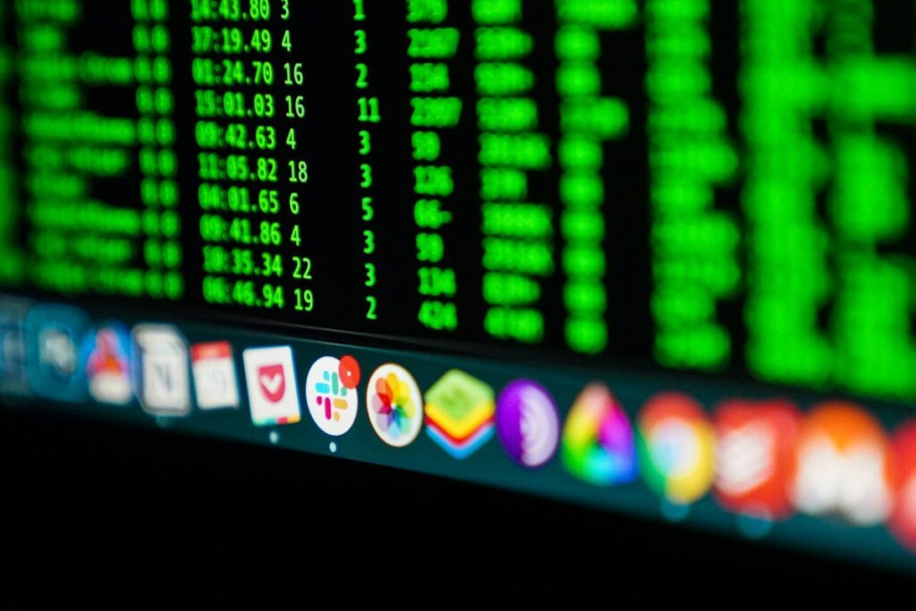 Green figures on a computer screen above a row of app icons