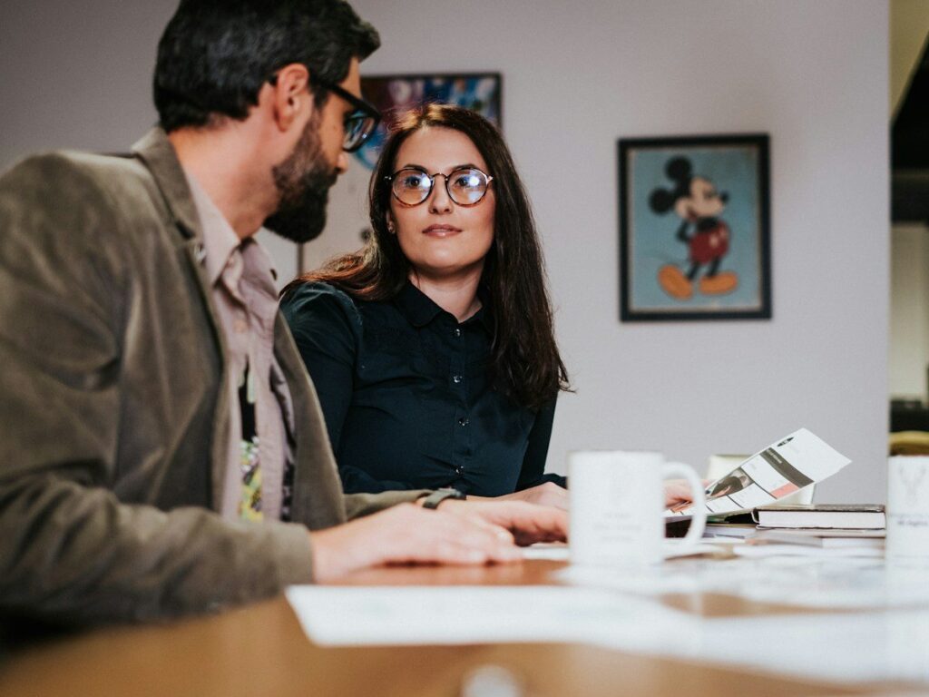 Two colleagues talking at a table