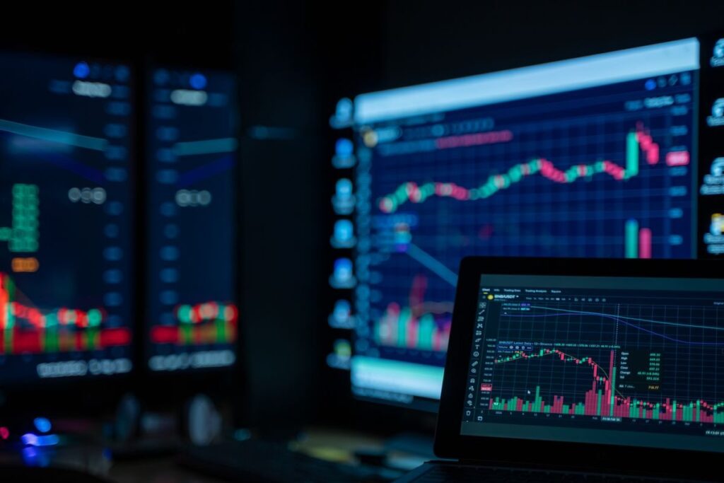 Wall of screens showing candlestick charts