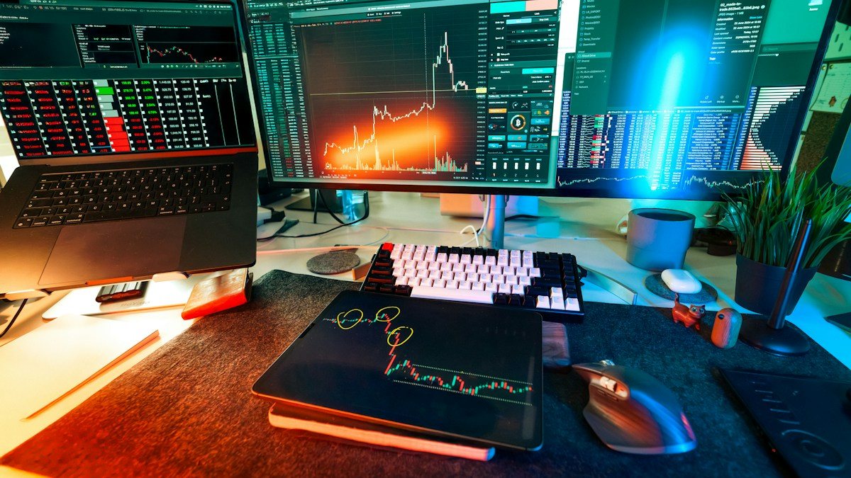 Trading desk with chart screens lit up, where deciding when not to trade matters as much as entries