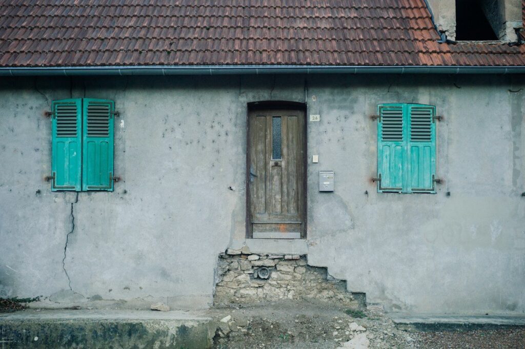 Weathered old house with a worn stone step, a picture of how repeated tests can wear down a zone